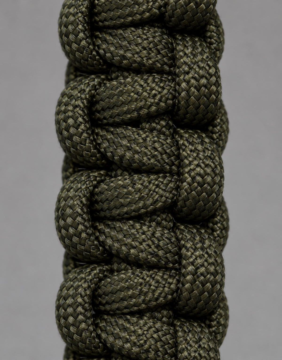 Close-up of the dark green cobra weave on the Naag paracord keychain