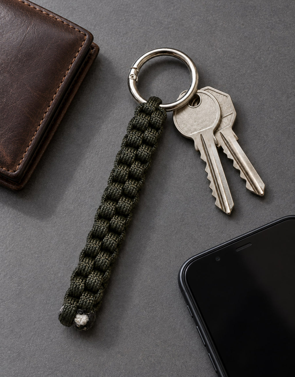 Saf dark green paracord keychain in an everyday carry flat lay